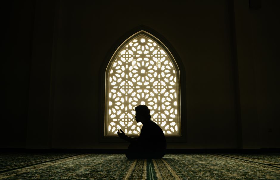 Silhouette of a person in prayer